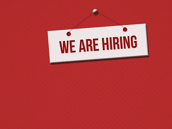 Red background with a white "We Are Hiring" sign in red text